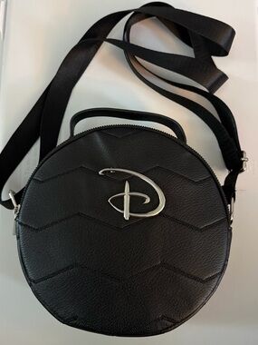 Black Round Crossbody Bag with Silver Emblem